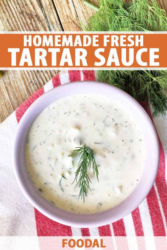 A small bowl of creamy tartar sauce, garnished with fresh herbs.