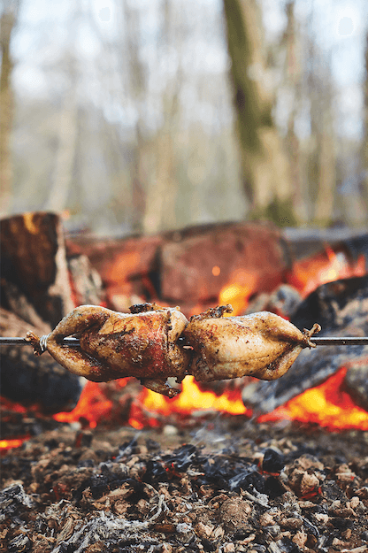 Partridge being grilled over open flames
