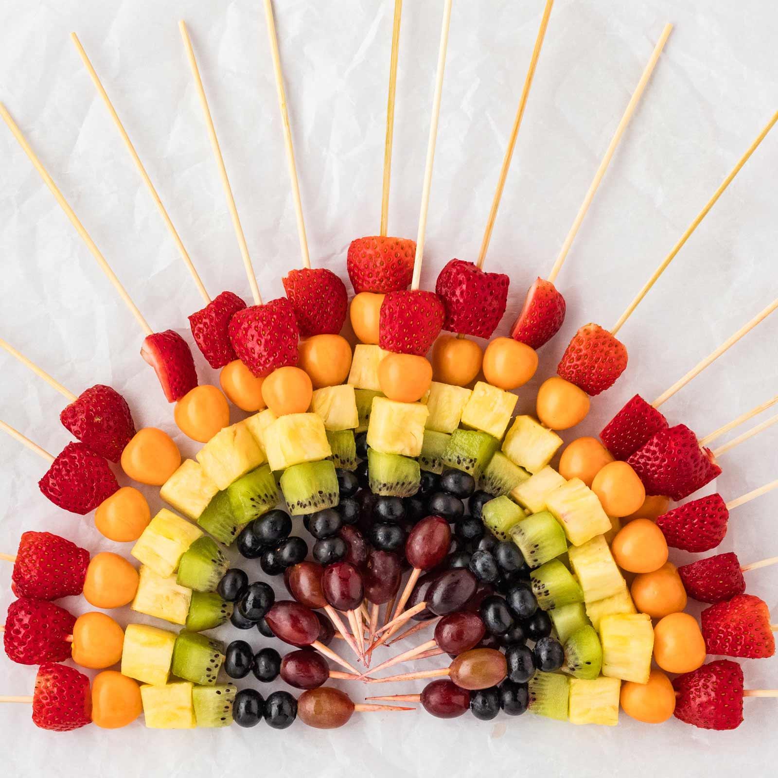 vibrant fruit skewers arranged like a rainbow