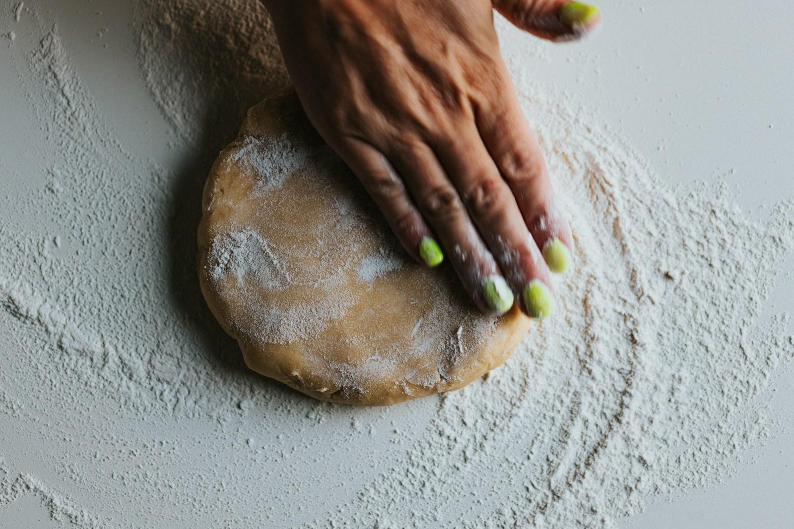 A person kneading roti dough