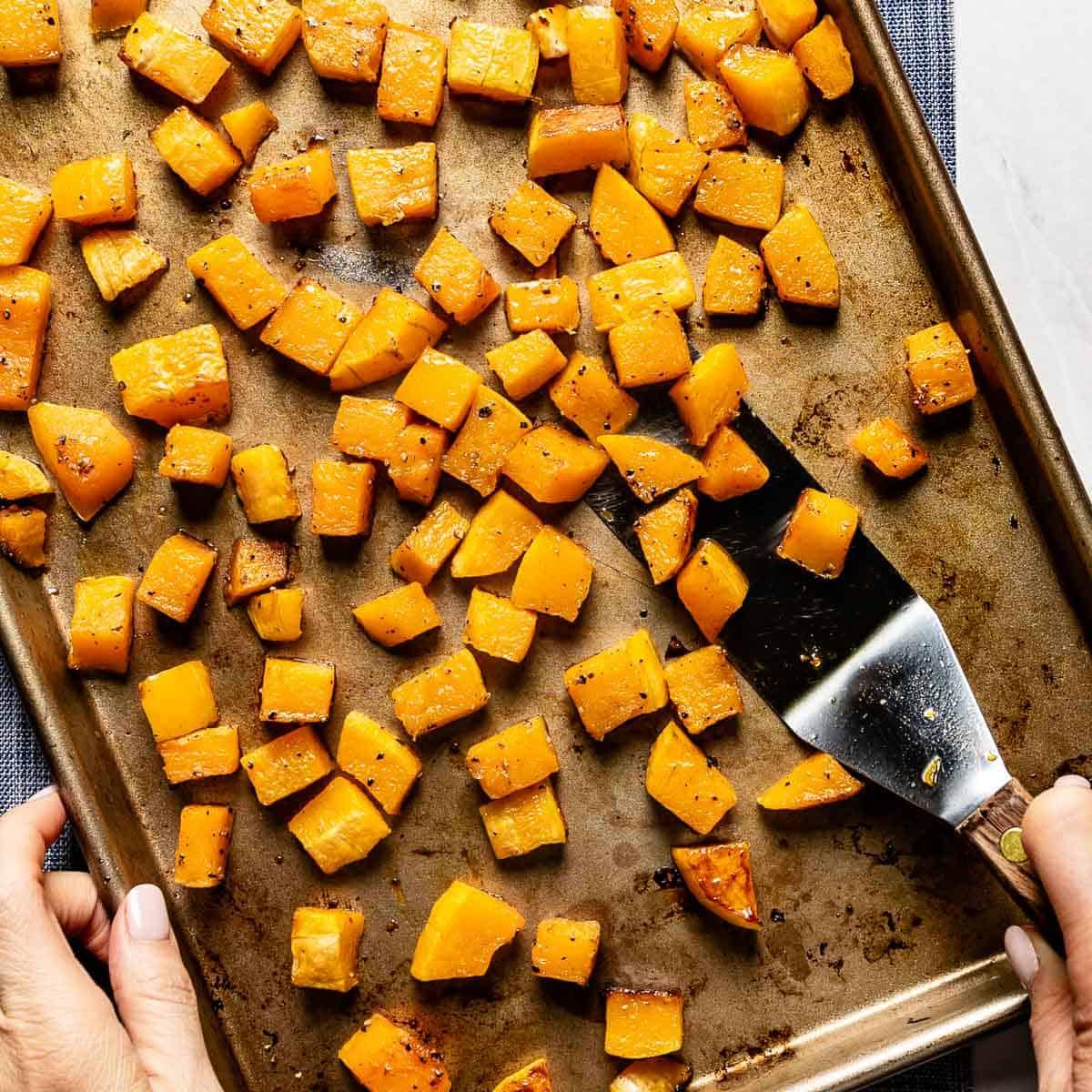 roasted butternut squash cubes on a baking sheet