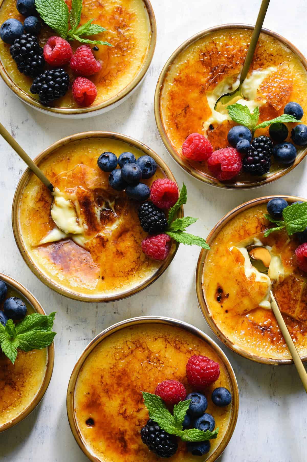 Vanilla bean crème brûlée with caramel sauce in ramekins