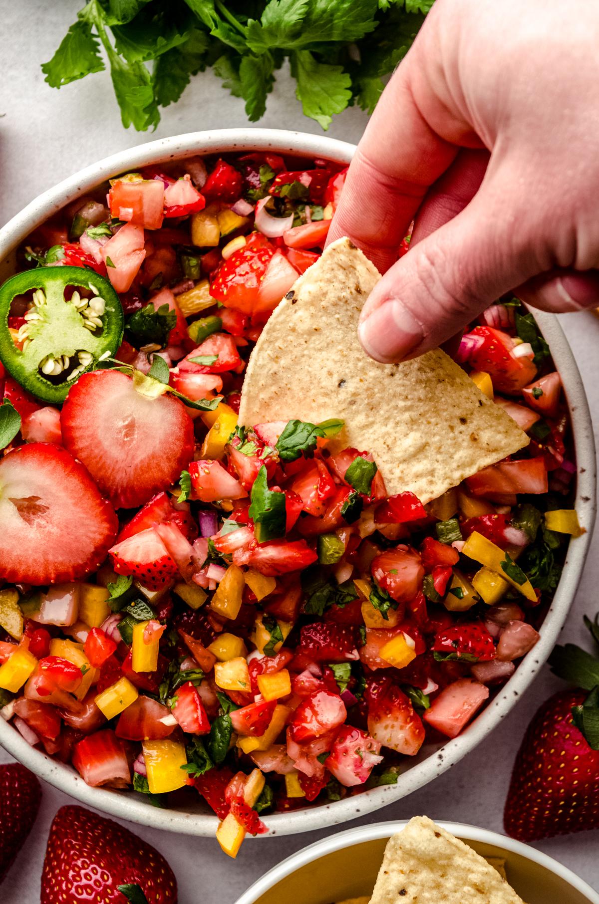 A table with various dishes featuring the strawberry salsa.