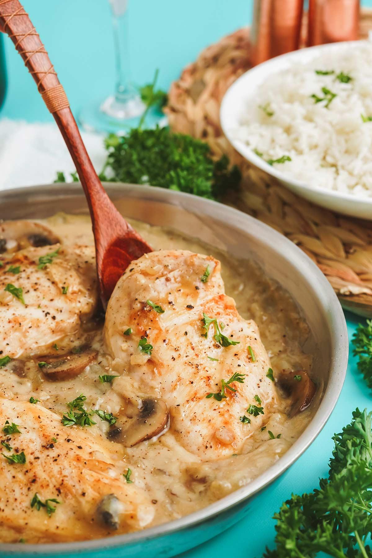 Close-up of shimmering champagne reduction sauce with a chicken breast