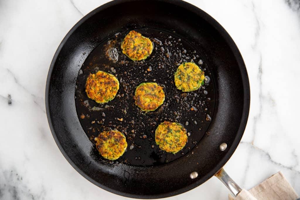 Close-up shot of nori falafel being fried in a skillet.