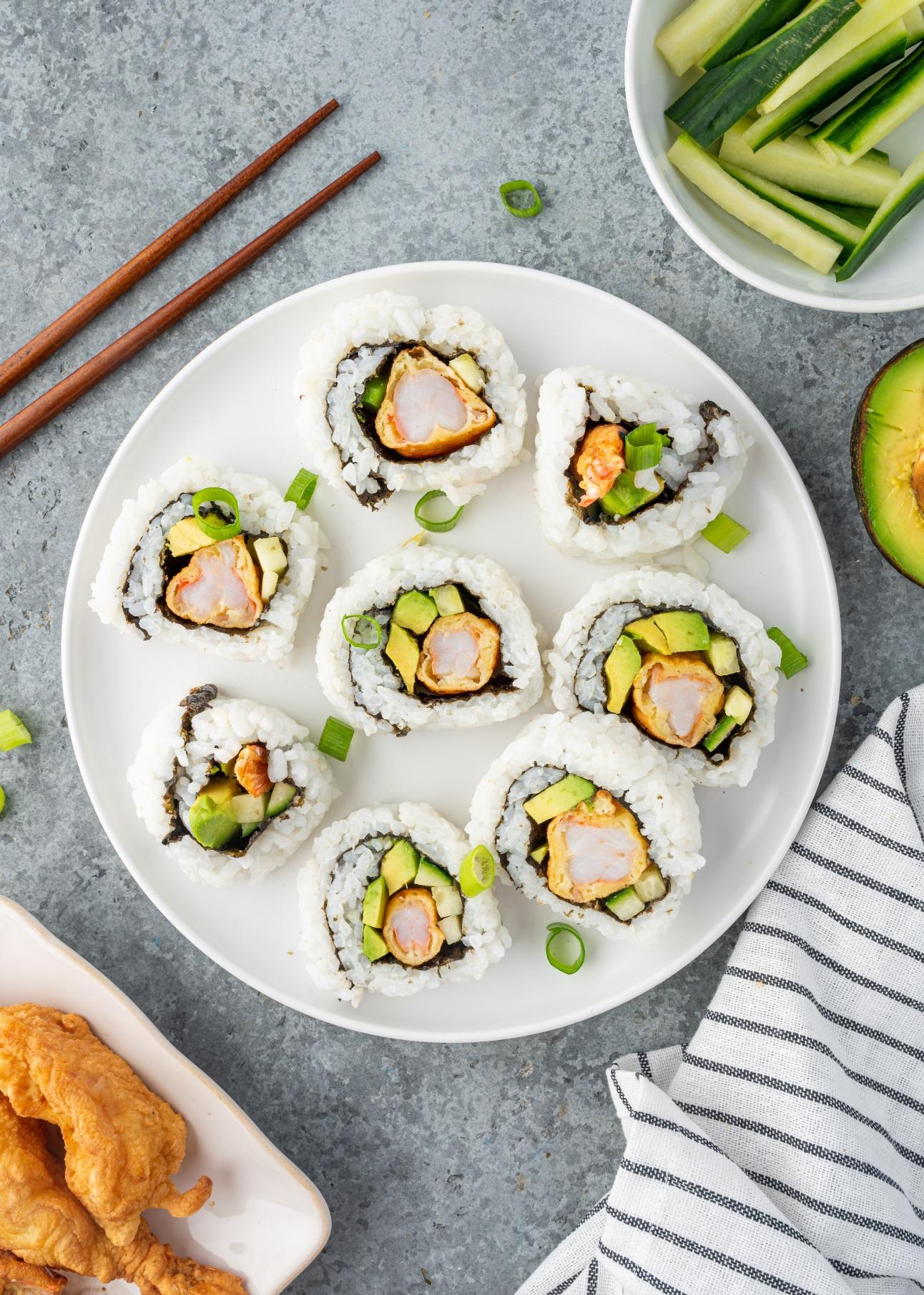 Plated crispy shrimp and avocado tempura dish, with a garnish
