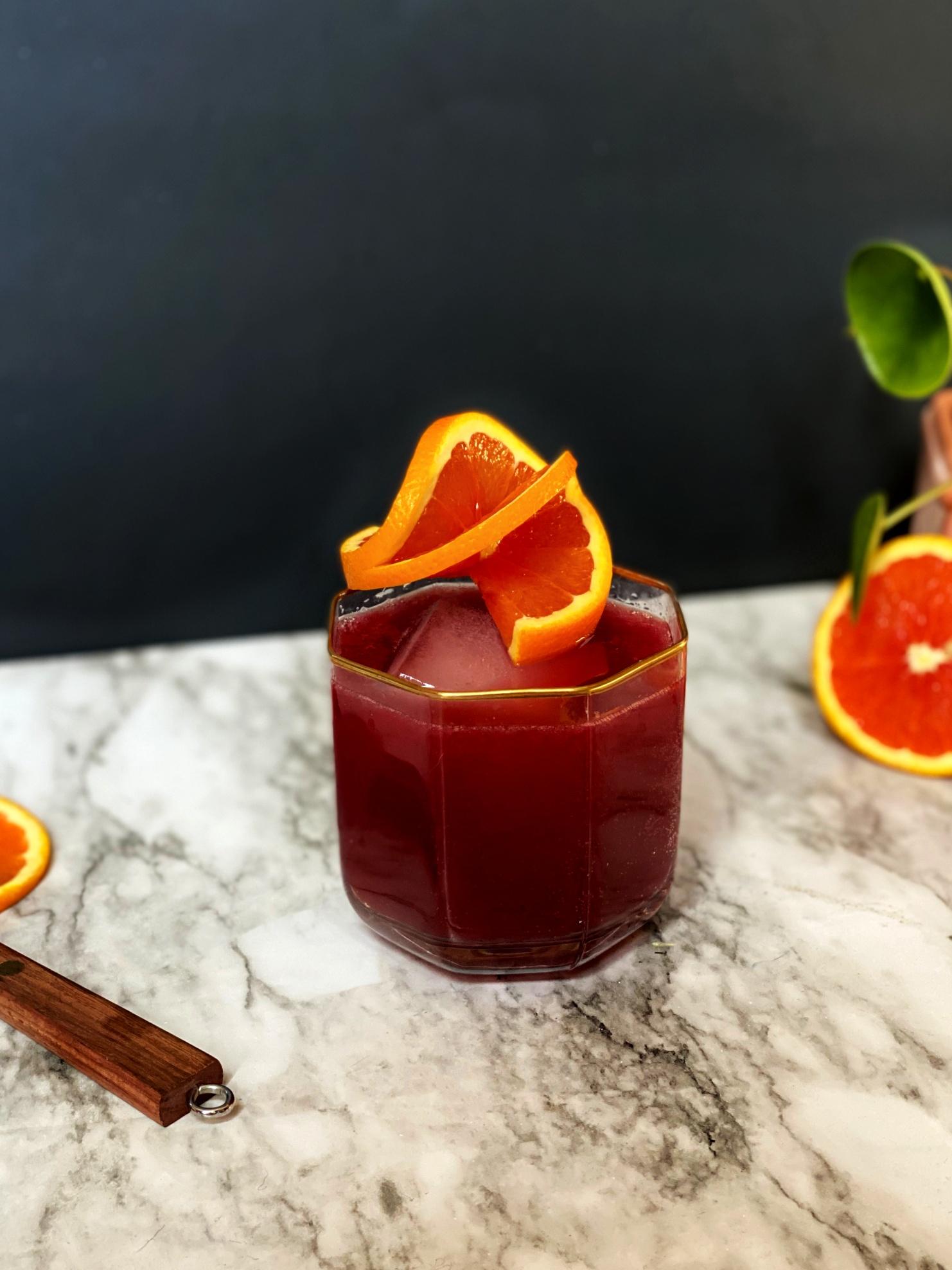 Sunset-hued kombucha drink with blood orange slices