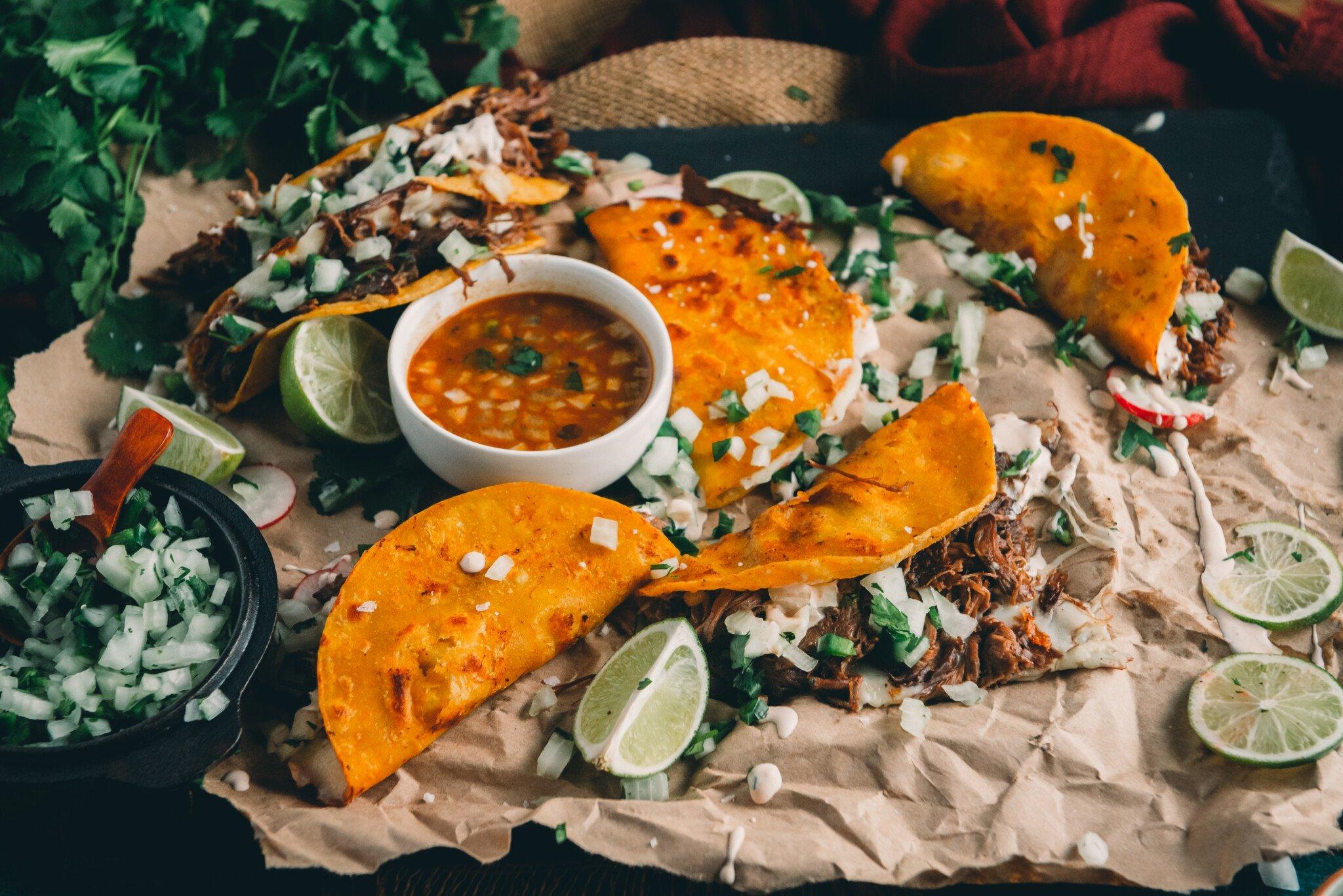 Tacos served on a rustic platter, garnished with cilantro