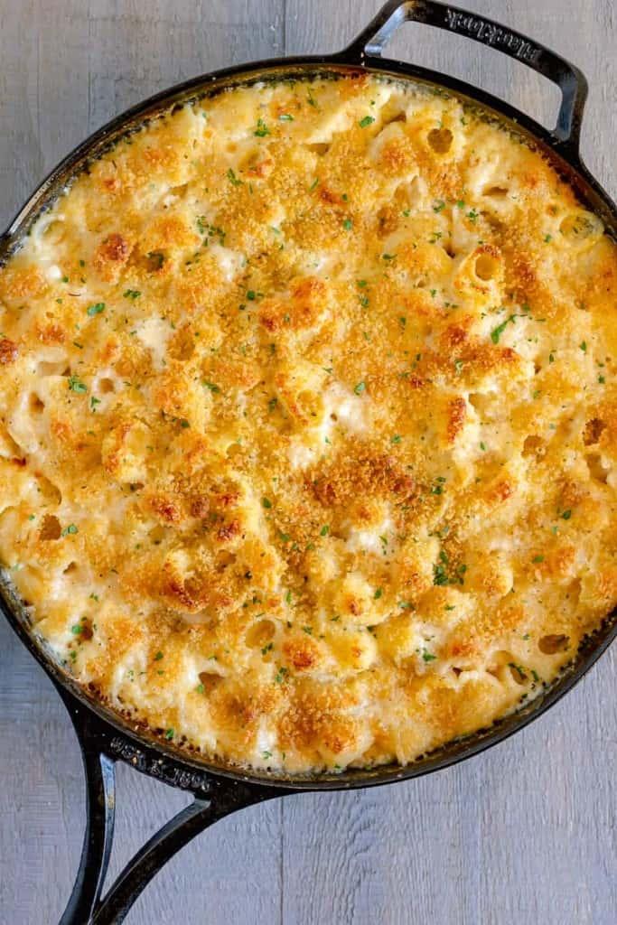 Overhead shot of creamy baked macaroni and cheese bubbling in a casserole dish, fresh out of the oven.