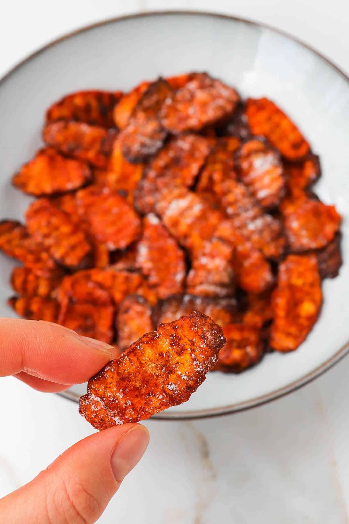 Close-up shot of a single cumin spiced carrot top chip