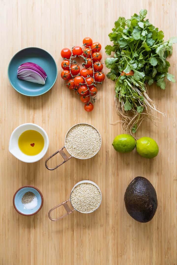 quinoa salad ingredients laid out on a wooden table