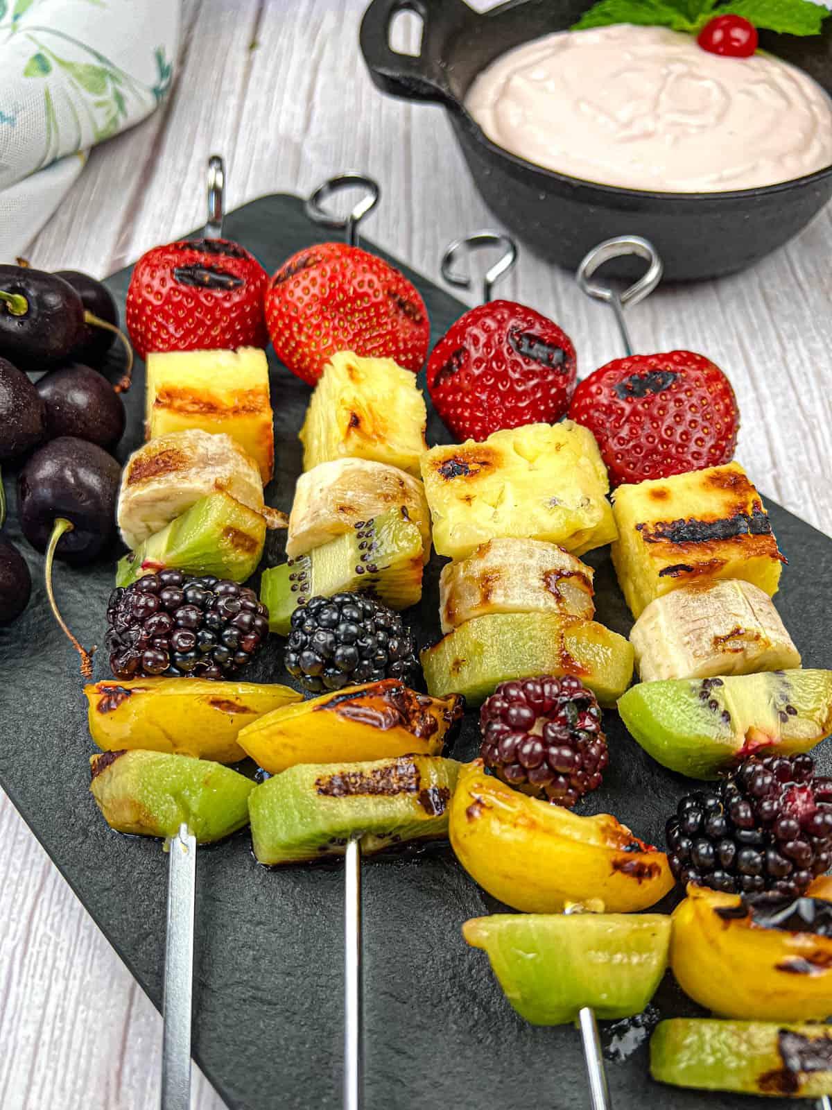 Colorful fruit kabobs on a grill