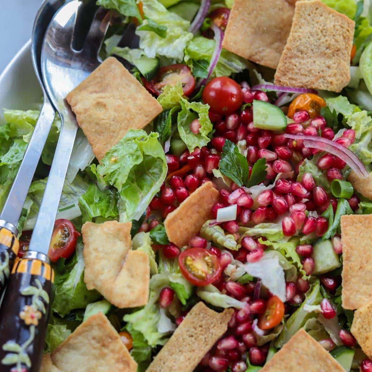 Close-up shot of a bowl of Bruneian Fattoush, highlighting the vibrant colors and textures of the ingredients.