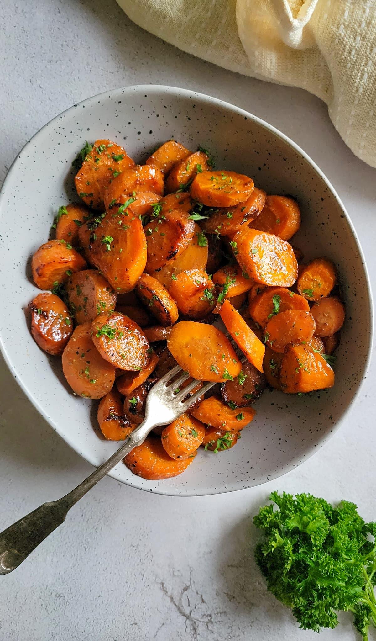 a bowl of Sweet Paprika & Honey Glazed Carrots garnished with fresh parsley