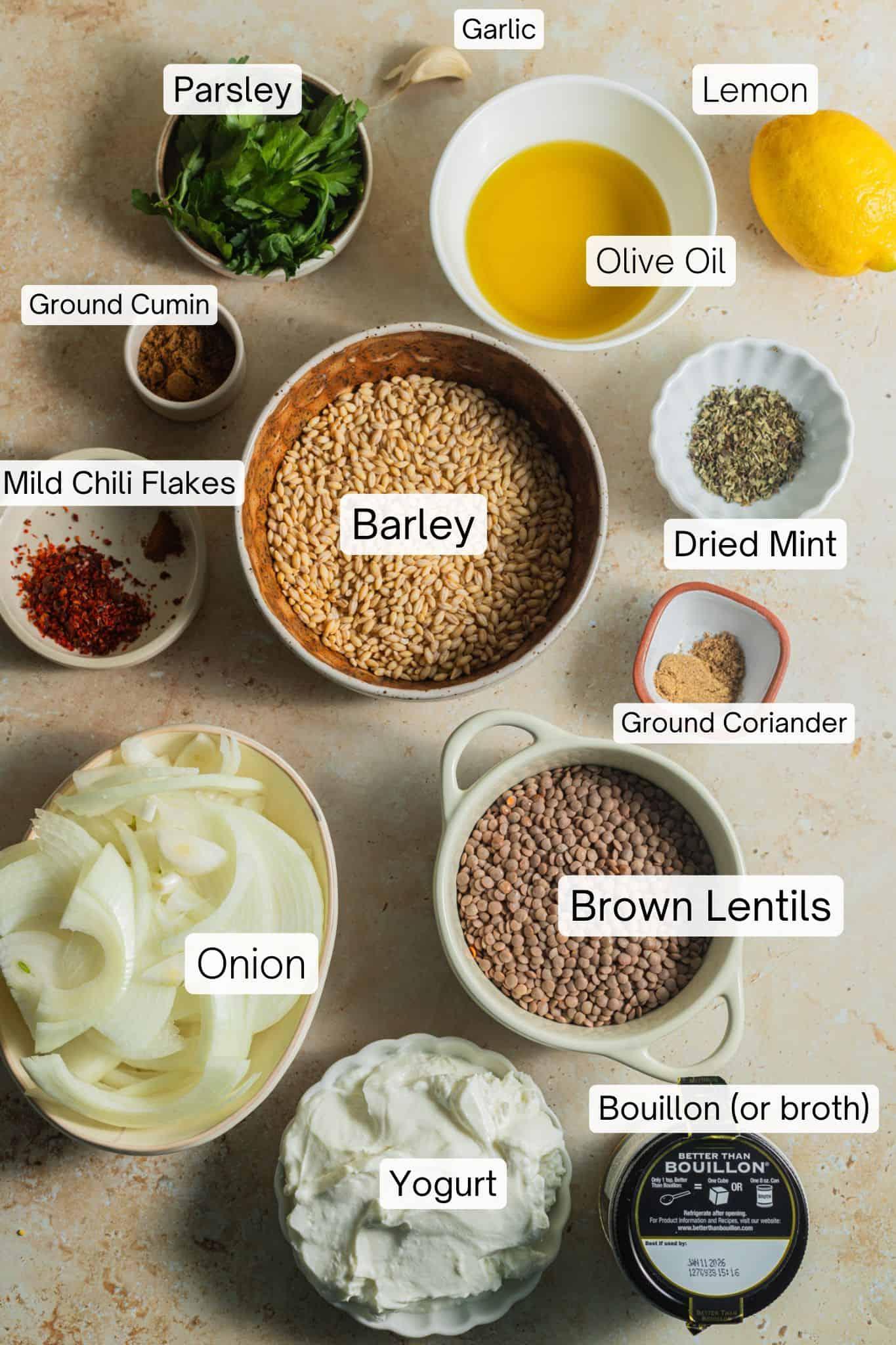 ingredients for barley and lentil dal arranged on a wooden board