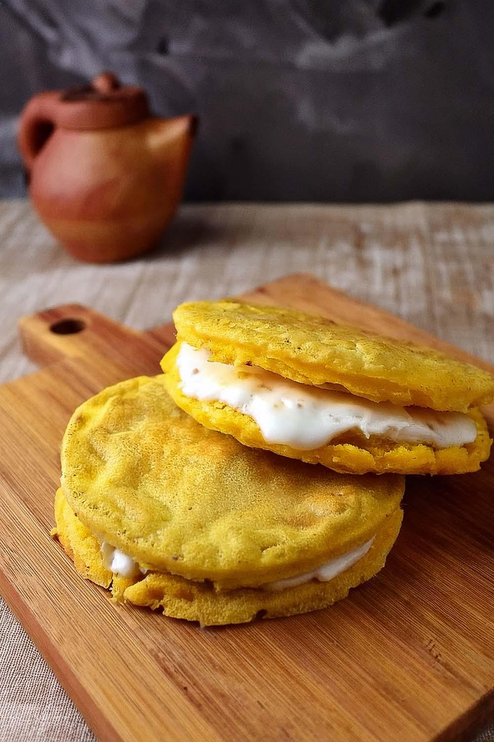 golden arepas filled with mozzarella and basil