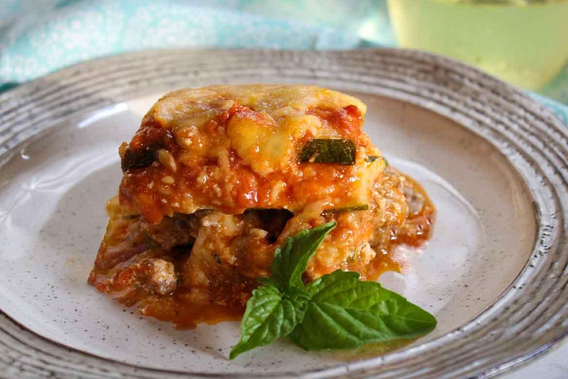 A close-up shot of a single serving of Zucchini Lasagna with Sweet Italian Sausage, showing the layered zucchini and sausage.