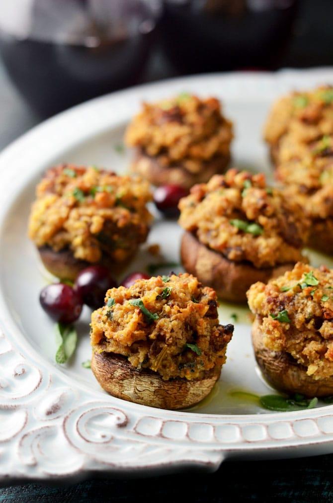 Close up of a single turkey and stuffing stuffed mushroom, showing the texture of the stuffing and the juicy mushroom cap