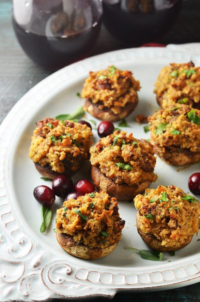 Close-up shot of several large turkey and stuffing-stuffed mushrooms, golden-brown and glistening, on a baking sheet