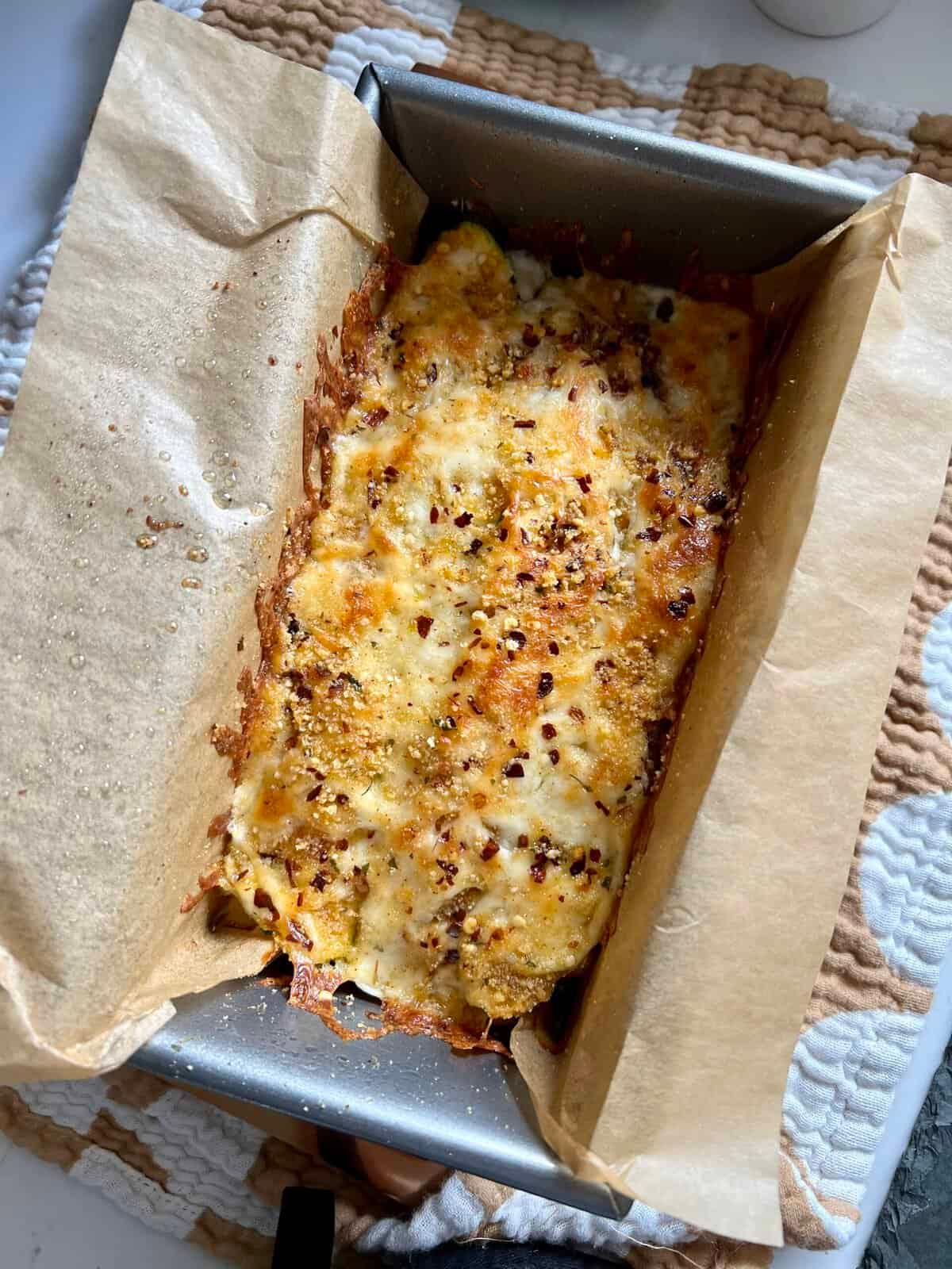 Close-up of a Prosciutto Parmesan Low-Carb Zucchini Lasagna being assembled