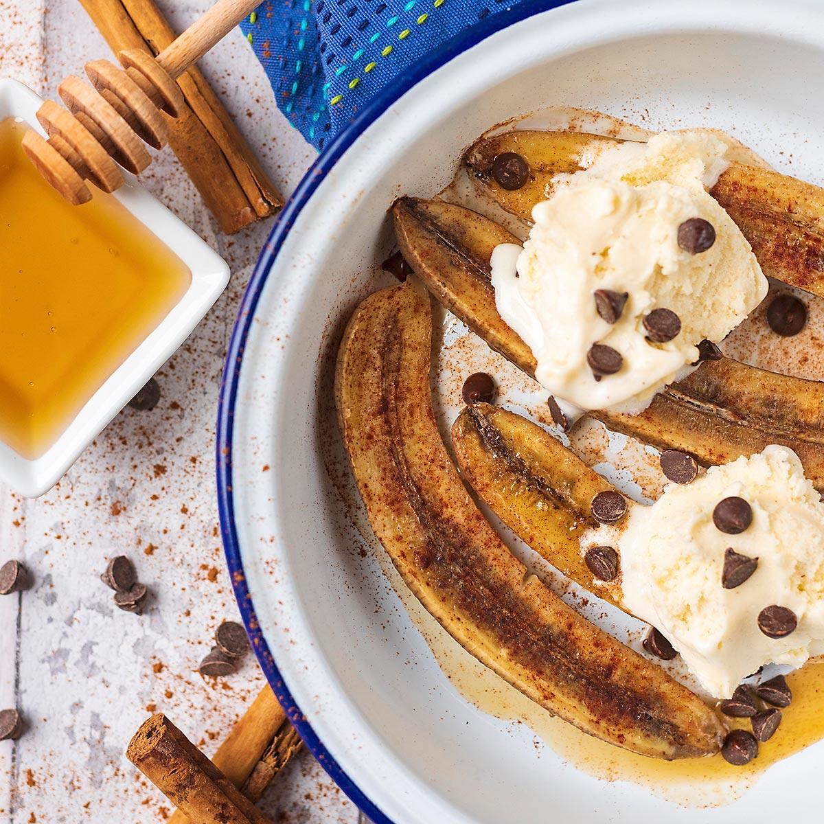 Close-up shot of baked bananas with honey drizzled on top
