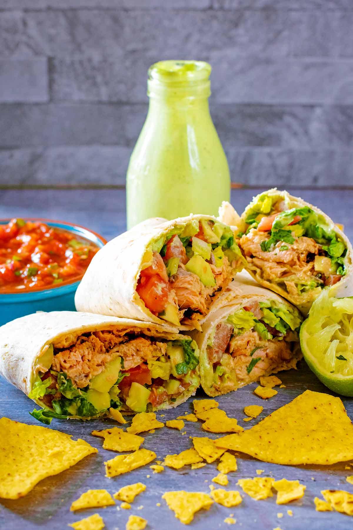Spicy Salmon Sunrise Burrito on a plate with a side of salsa.
