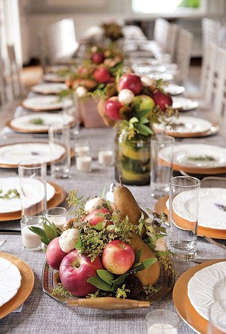 A rustic wooden table set for dinner with the stuffed peppers as the centerpiece.
