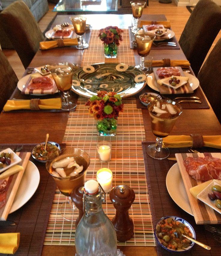 A wide shot of a table set for dinner, featuring the Red Lentil and Vegetable Paella as the centerpiece