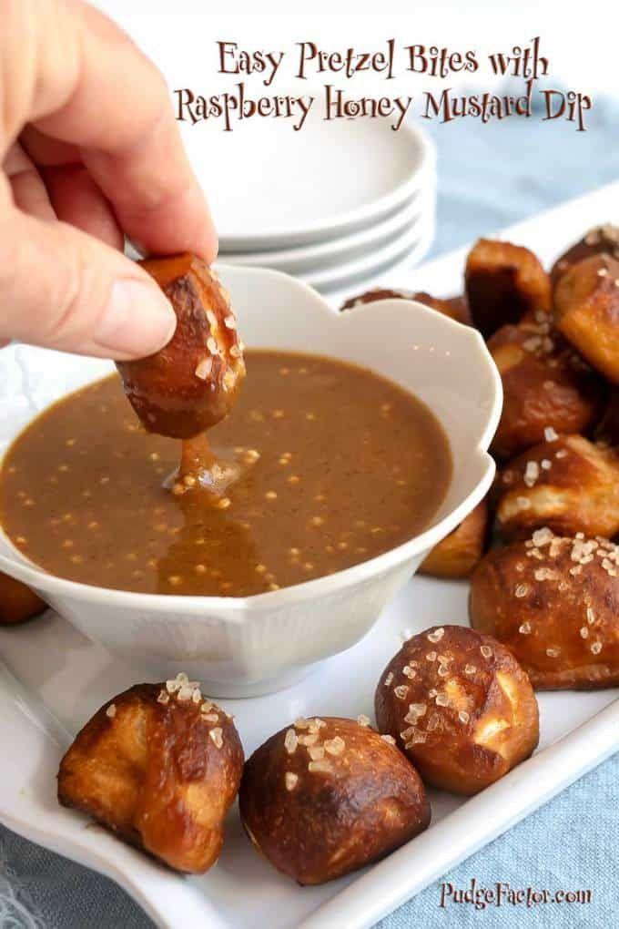 A bowl of raspberry glaze and a plate of beer pretzel bites