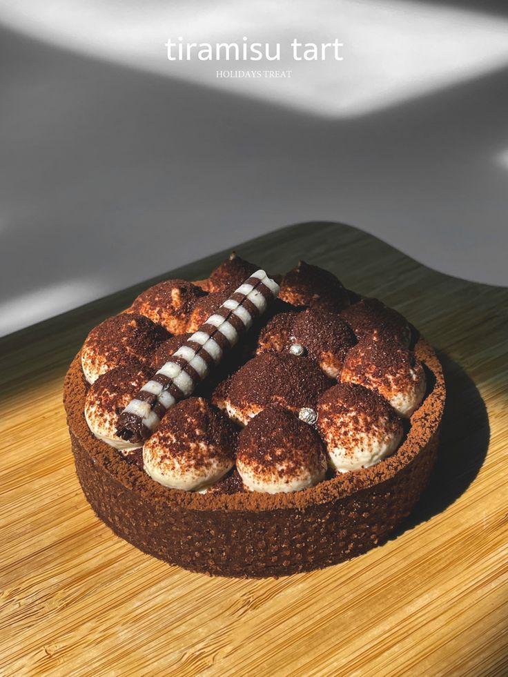 A beautifully styled tiramisu tart on a rustic wooden table