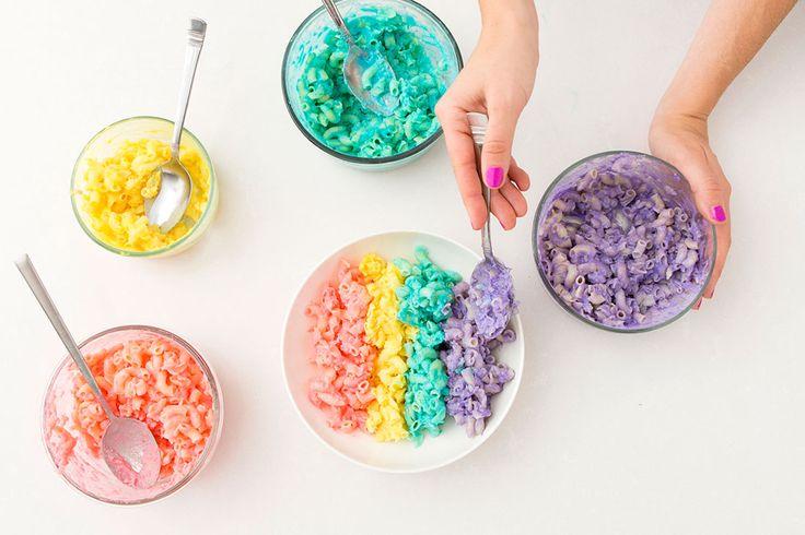 close up of rainbow mac and cheese being dished out with a serving spoon, colorful and cheesy