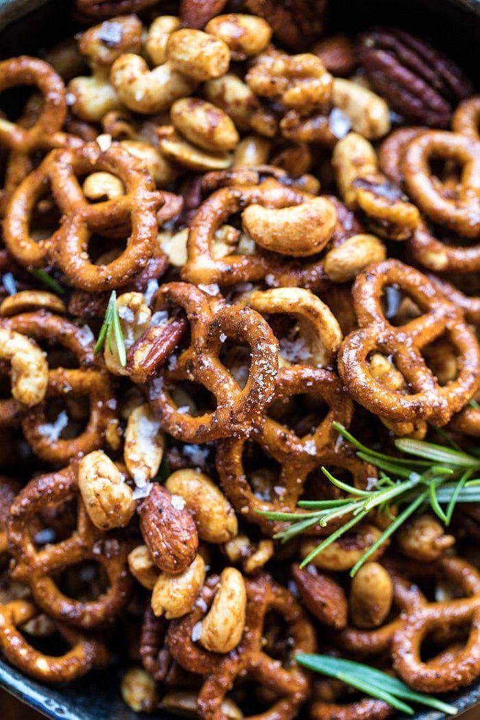 A bowl of pretzels with rosemary sprigs