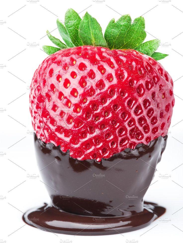 Close-up shot of a person dipping a strawberry into the Key Lime Chocolate Fondue, showing the rich texture and vibrant colors.