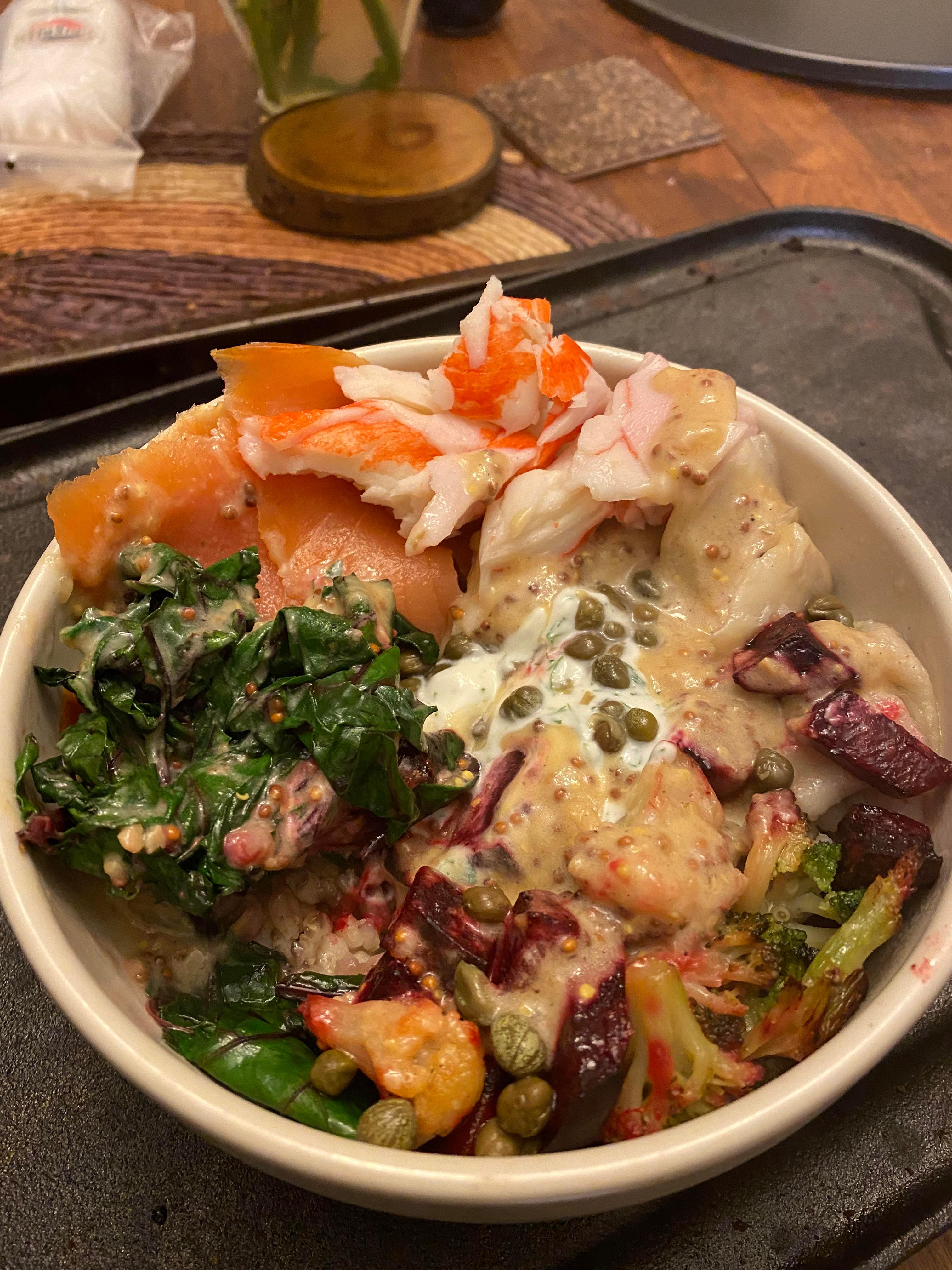 finished herring poke bowl with sour cream and chives on a table