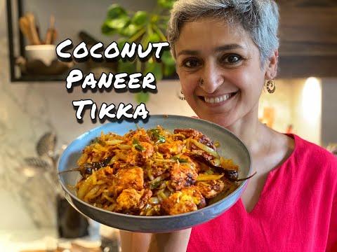 A person enjoying a plate of Paneer Tikka with Creamy Coconut Sauce