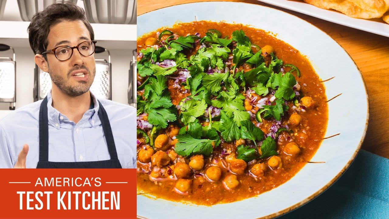 overhead shot of a person preparing chana masala in a kitchen