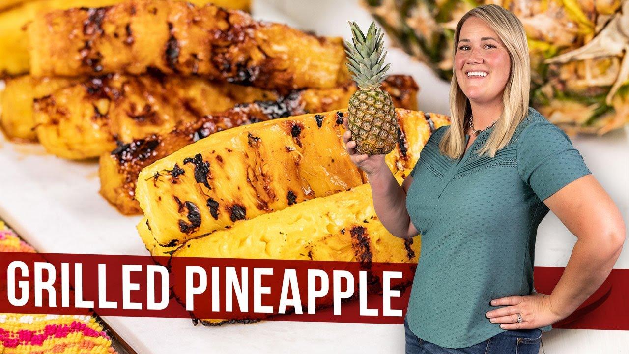 A person grilling pineapple slices on a barbecue.