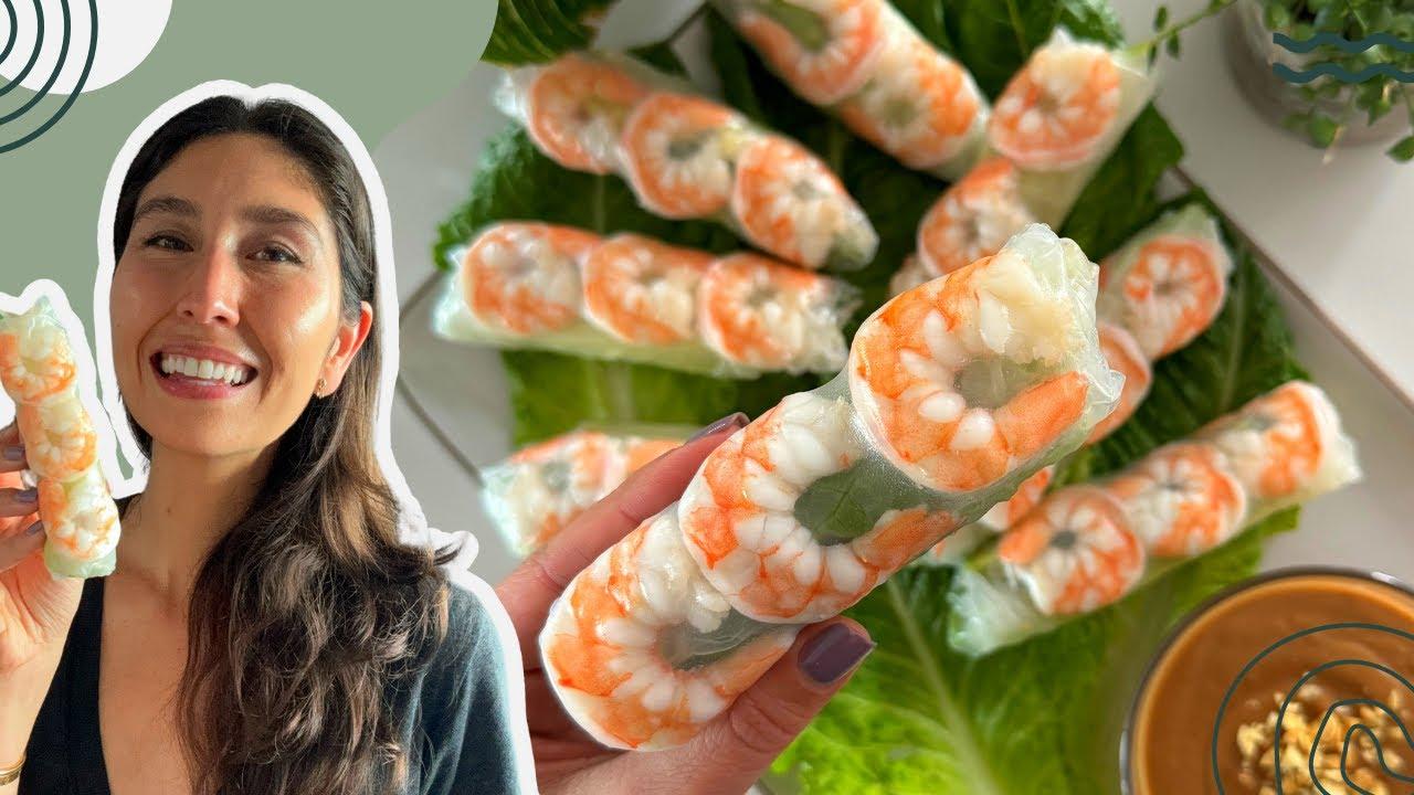 A group of friends laughing and enjoying edamame and shrimp spring rolls together.