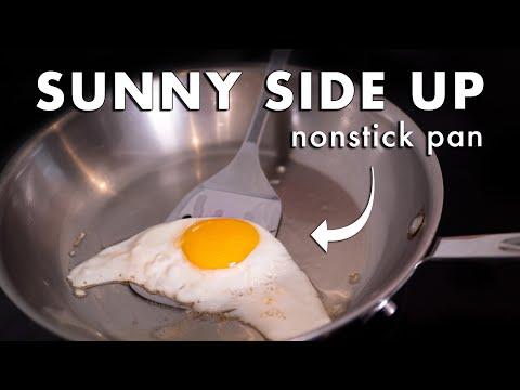 Close-up shot of perfectly sautéed eggs in a non-stick skillet, glistening with apple juice