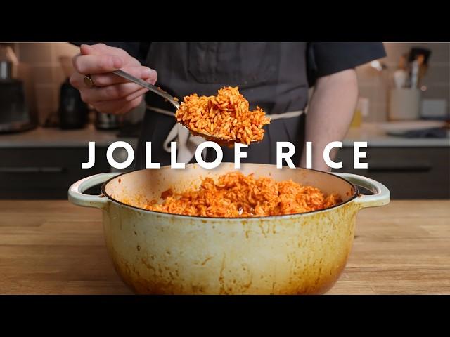 a cook stirring Jollof Rice in a large pot
