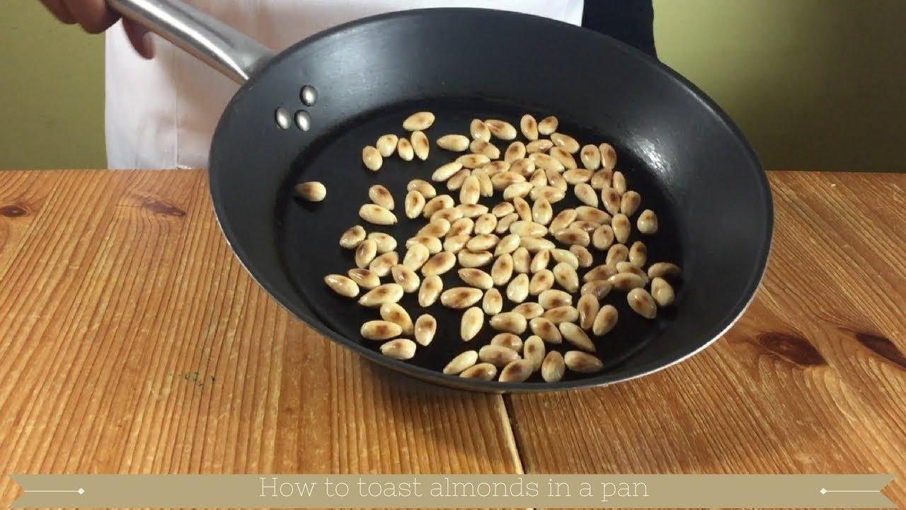 chef toasting almonds in a pan