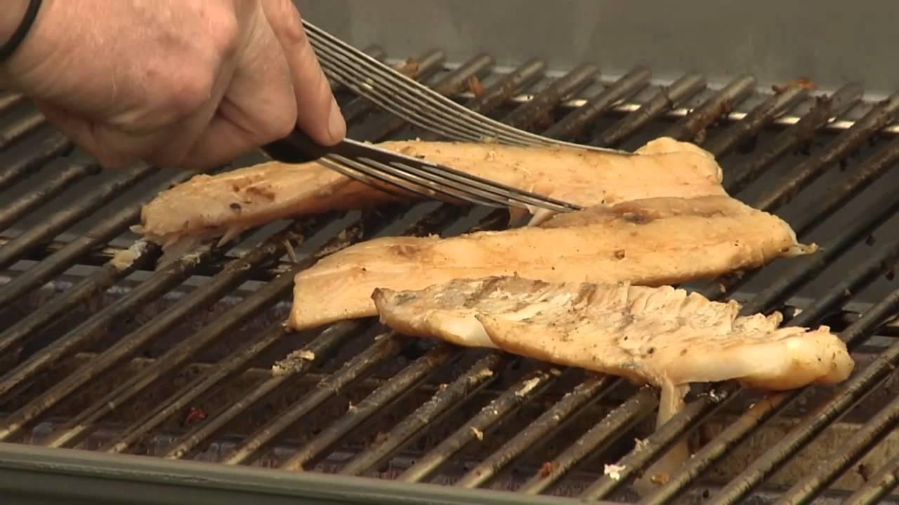Person grilling fish fillets