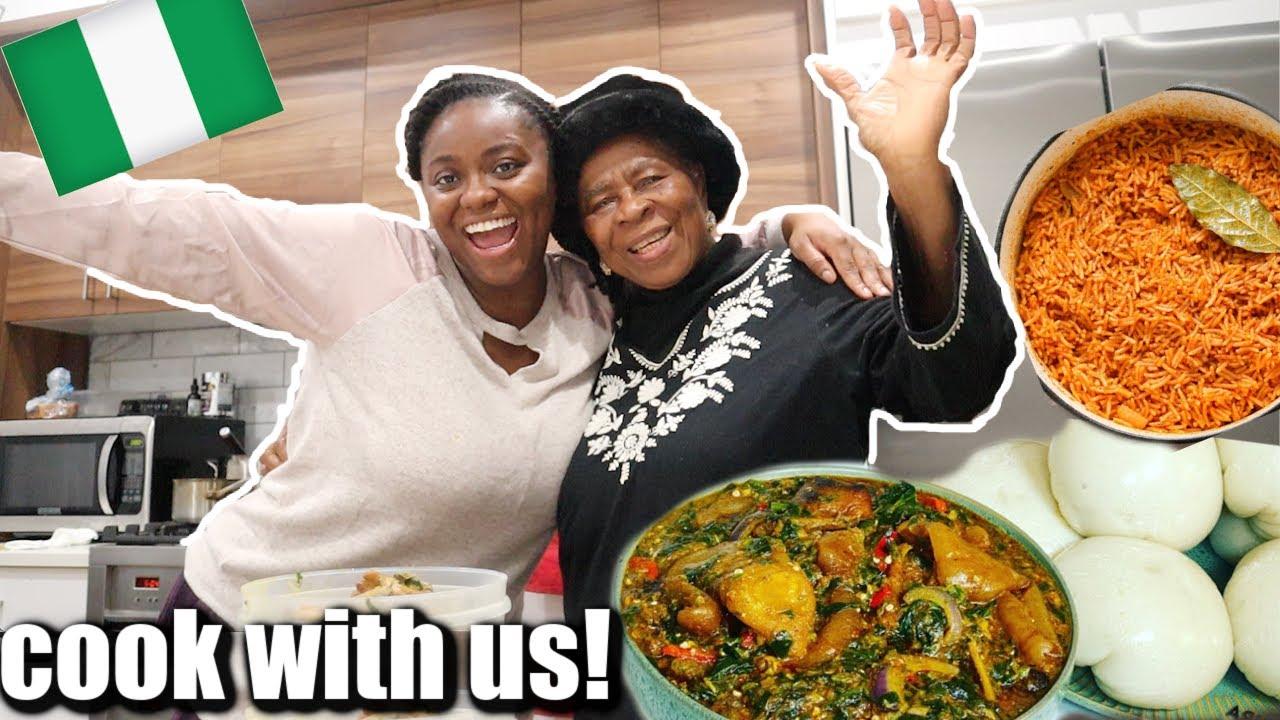 Close-up shot of a person stirring a pot of Jollof rice with okra.