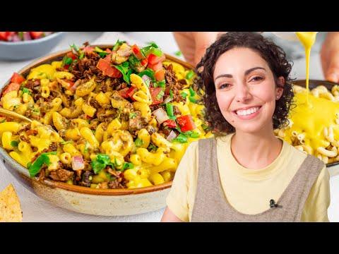 A close-up shot of a person enjoying a large serving of Taco Mac and Cheese.
