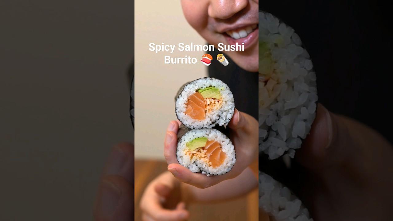 Close-up of someone assembling a Spicy Salmon Sunrise Burrito.