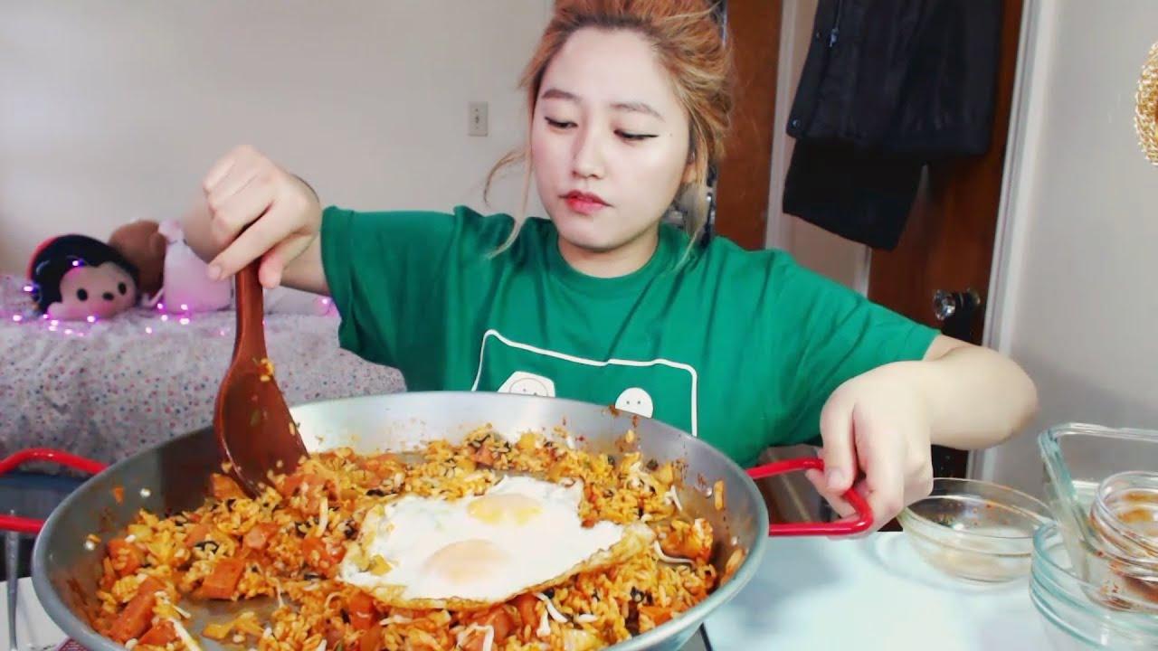 a person eating kimchi fried rice with chopsticks