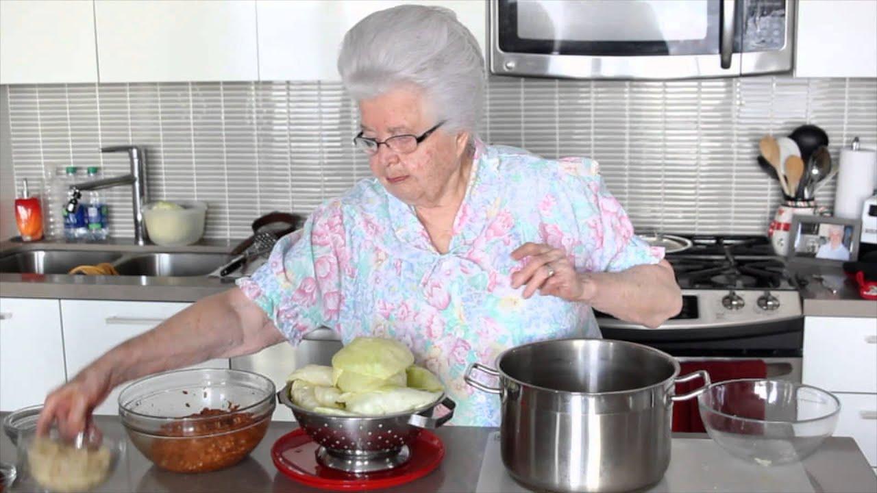 Grandmother in the kitchen making pork and cabbage rolls.
