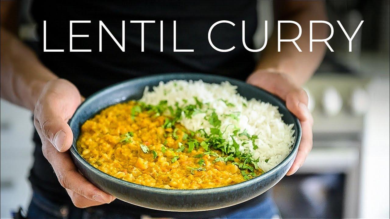 A person serving a bowl of Curried Lentil and Coconut Rice