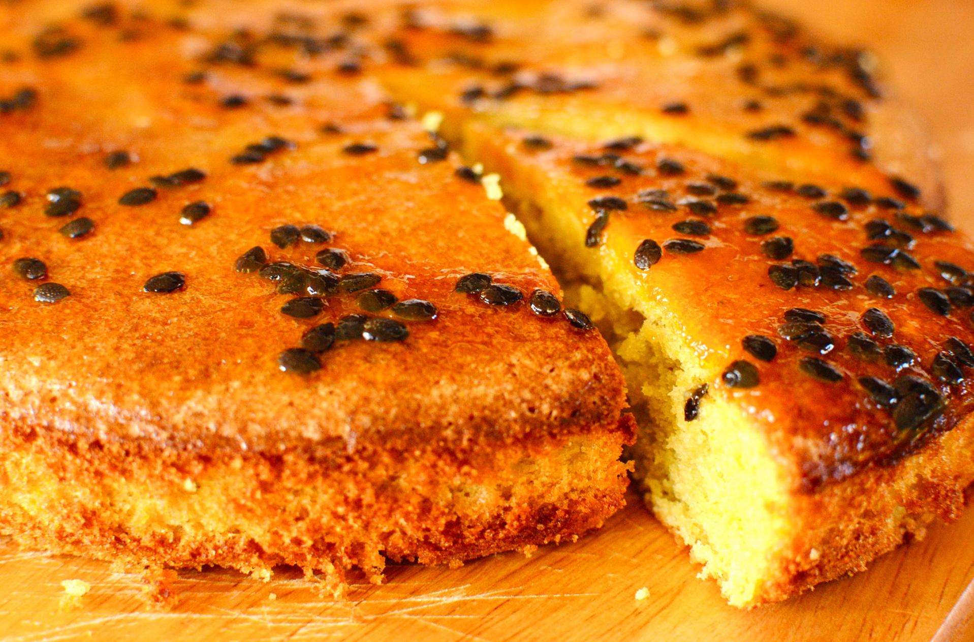 a slice of polenta cake with passion fruit curd and zest