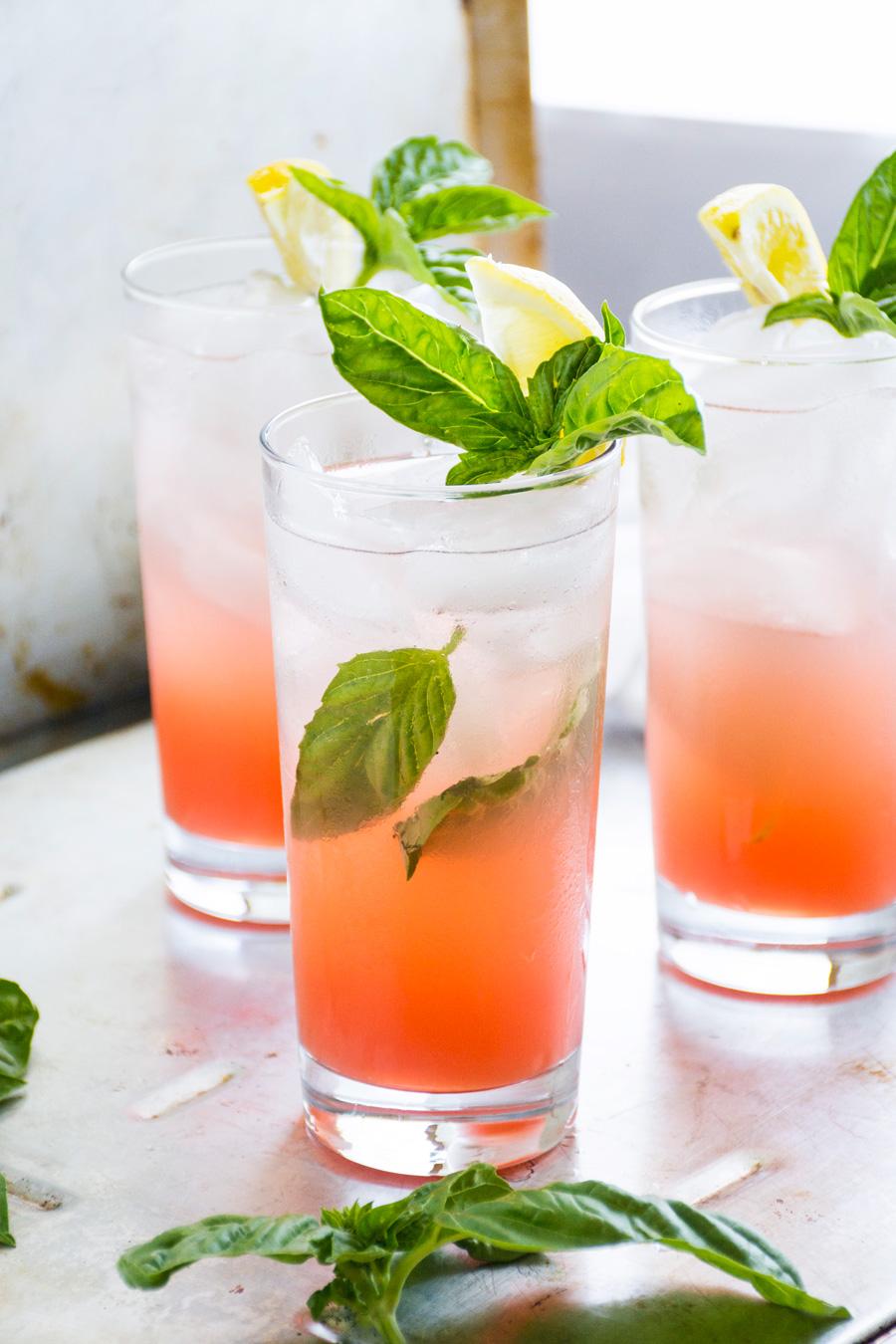 Glass of grapefruit lemonade with honey drizzle on a sunny patio